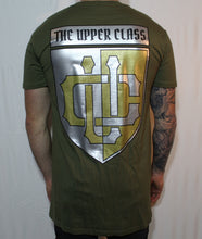 Load image into Gallery viewer, Olive green tall tee with gold and silver shield print